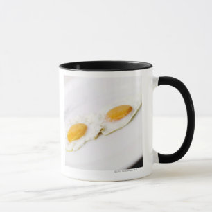 Close-up of two fried eggs mug