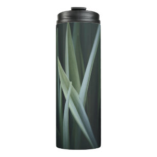 Close up photo of green linear leaves thermal tumbler