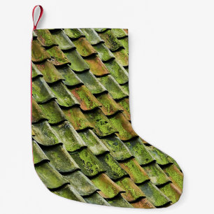 Close-up photo of green shingle roof small christmas stocking