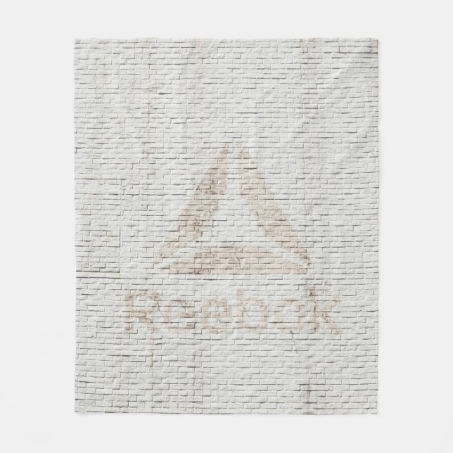 Close-up photo of Reebok logo on wall Fleece Blanket (Front)
