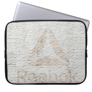 Close-up photo of Reebok logo on wall Laptop Sleeve