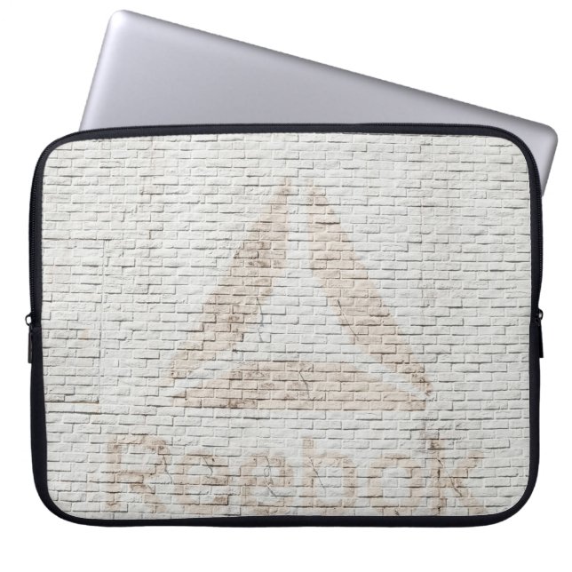 Close-up photo of Reebok logo on wall Laptop Sleeve (Front)