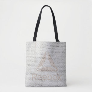 Close-up photo of Reebok logo on wall Tote Bag