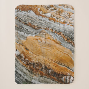 Close-up photography of grey and orange stones sherpa blanket