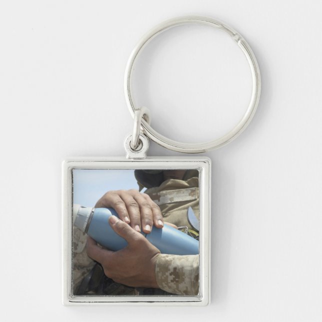 Close-up view of a soldier cradling a munition key ring (Front)
