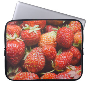 Close-up view on fresh summer strawberry with vint laptop sleeve