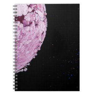 Close view of pink planet cartoon image notebook