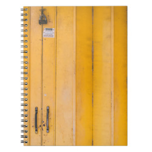 CLOSED YELLOW WOODEN DOOR WITH PADLOCK NOTEBOOK