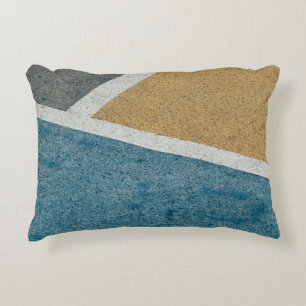 Closeup grey, yellow, and blue painted pavement decorative cushion