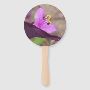 closeup of a purple plant and a tiny bee hand fan