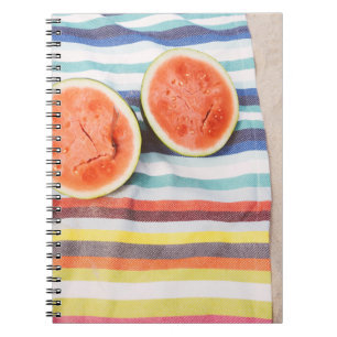 Closeup photo of slice watermelon fruits on cloth notebook