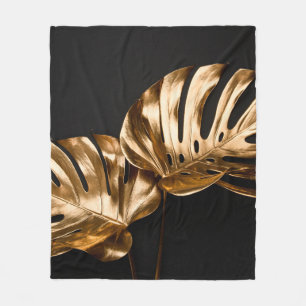 Closeup view of two luxurious golden painted tropi fleece blanket