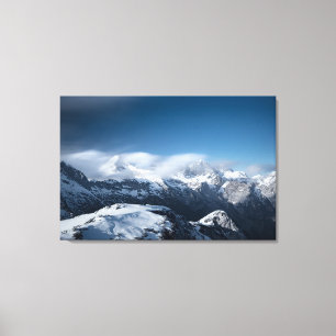 Clouds rolling above snowy mountains canvas print