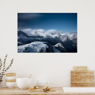 Clouds rolling above snowy mountains poster