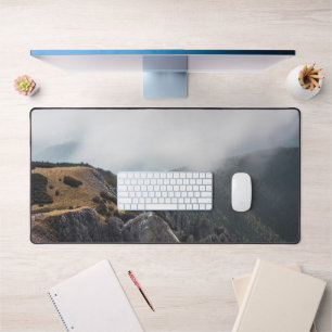 Clouds rolling over mountains desk mat
