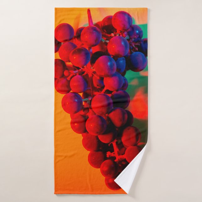 Cluster of blue grape in orange neon light. Food b Bath Towel (Bath Towel)