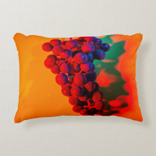 Cluster of blue grape in orange neon light. Food b Decorative Cushion