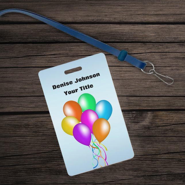 Cluster of Colourful Balloons Matching Ribbon Blue ID Badge (Bunch colourful balloons various colours with streamers on blue ID Badge.)