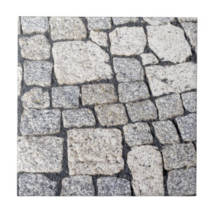 Cobblestones of a street in detail tile
