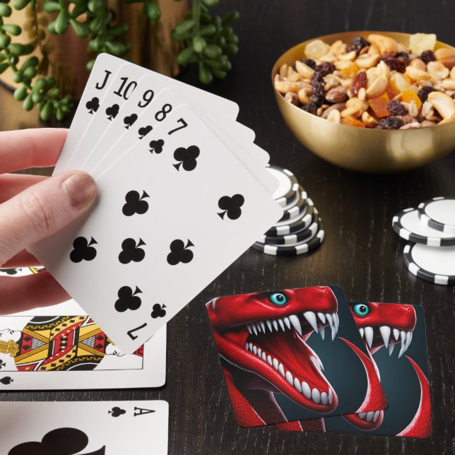 Cobra snake with vibrant red scales and blue eyes playing cards (In Situ)