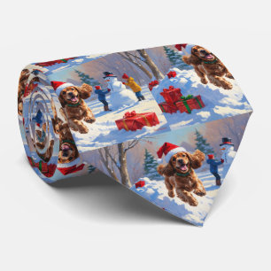 Cocker Spaniel Running in Snow with Christmas Hat Tie