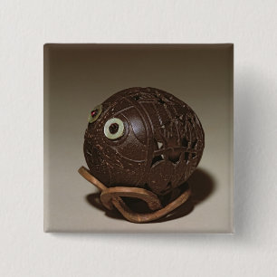 Coconut sculpted into a face, c.1895 15 cm square badge