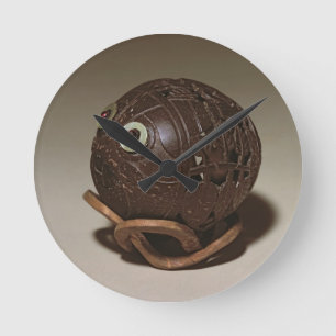 Coconut sculpted into a face, c.1895 round clock