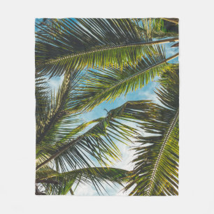 Coconut tree leaves under blue sky in the morning fleece blanket