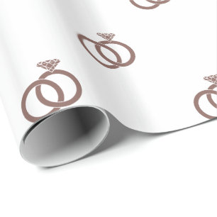 Cognac Brown Wedding Rings on White Wrapping Paper