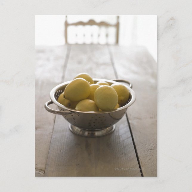 Colander with lemons on wooden table postcard (Front)