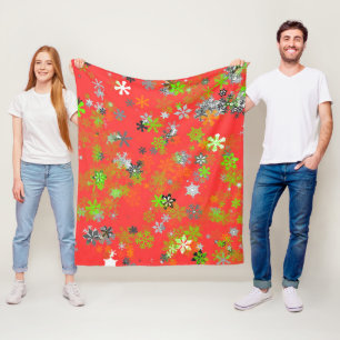 COLORED SNOW FLAKES ON RED FLEECE BLANKET