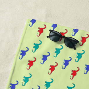 Colorful dino on green beach towel