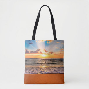 Colorful ocean beach sunrise with deep blue sky an tote bag