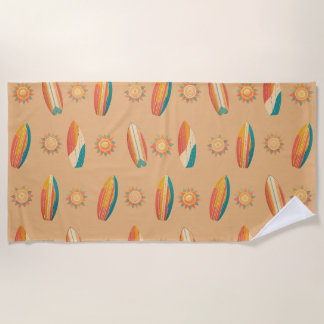 Colorful surfboards and suns against golden sand. beach towel