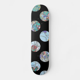 Colourful blue green red circles on black skateboard