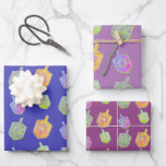 Colourful Bright Spinning Dreidels Purple Hanukkah Wrapping Paper Sheet<br><div class="desc">A modern and colourful Hanukkah gift wrapping paper featuring colourful bright star of David twirling dreidels on a 3 shades of purple background.</div>