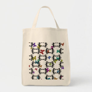 Colourful butterflies behind an iron gate tote bag