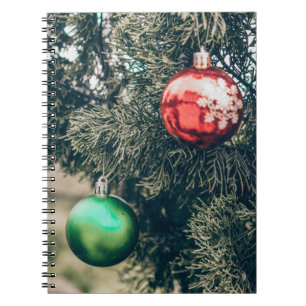 Colourful Christmas bauble decoration on a tree. V Notebook