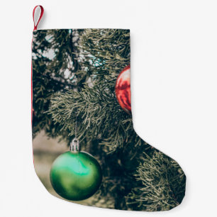 Colourful Christmas bauble decoration on a tree. V Small Christmas Stocking