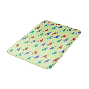 Colourful dinosaurs pattern on green bath mat