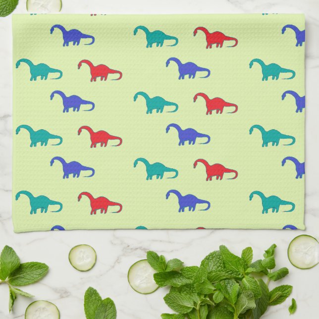 Colourful dinosaurs pattern on green tea towel (Folded)