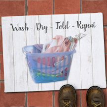 Colourful Folded Laundry On Hangers In Blue Basket