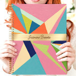 Colourful Geometric Abstract Custom Name Planner<br><div class="desc">This bold design showcases a vibrant geometric abstract pattern with vivid pink, blue, green, and orange tones. The central gold band elegantly highlights a custom name, creating a stylish and personal touch. Perfect for staying organised in school, work, or everyday life, this trendy design combines artistic flair with practicality. Whether...</div>