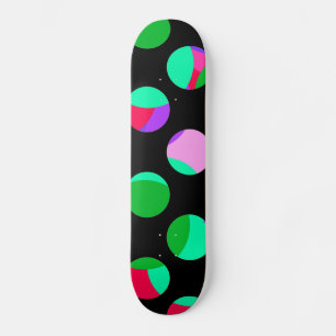 Colourful green purple circles on black skateboard