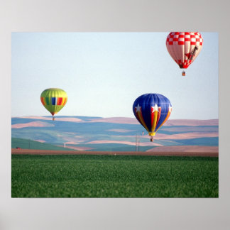 Colourful hot air balloons float over wheat poster