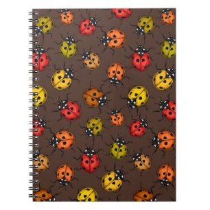 Colourful ladybugs on brown notebook