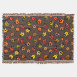 Colourful ladybugs on brown throw blanket