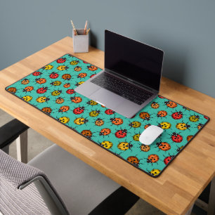 Colourful ladybugs on turquoise desk mat