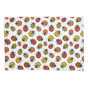 Colourful ladybugs on white pillowcase