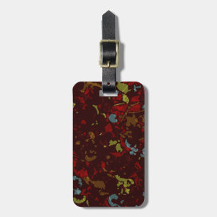 Colourful leaves and flowers against camouflage luggage tag